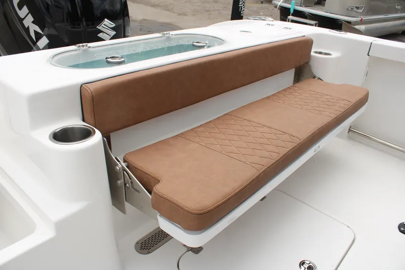 Slide: The Image of 2024 Sea Pro 222 boat with brown cushioned seating and livewell. - 12
