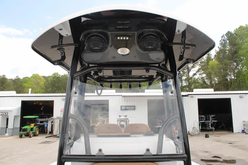 Slide: The Image of 2024 Sea Pro 222 boat with T-top and electronics, docked at a marina. - 14