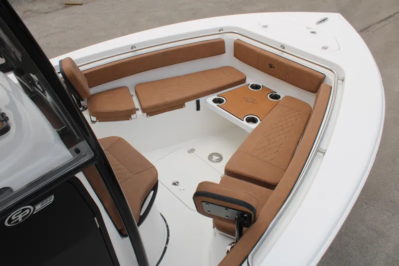 Slide: The Image of 2024 Sea Pro 222 boat interior with brown cushioned seating and cup holders. - 20