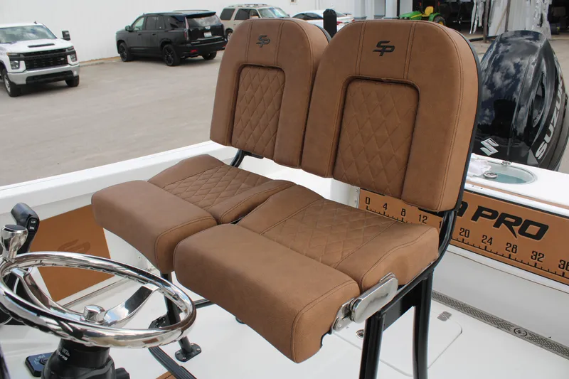 Slide: The Image of 2024 Sea Pro 222 boat with brown cushioned seats and steering wheel. - 21