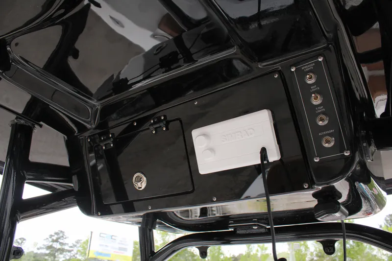 Slide: The Image of 2024 Sea Pro 222 boat console with Simrad electronics and storage compartments. - 23