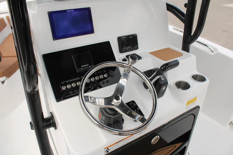 Slide: The Image of 2024 Sea Pro 222 boat console with steering wheel, controls, and navigation display. - 25