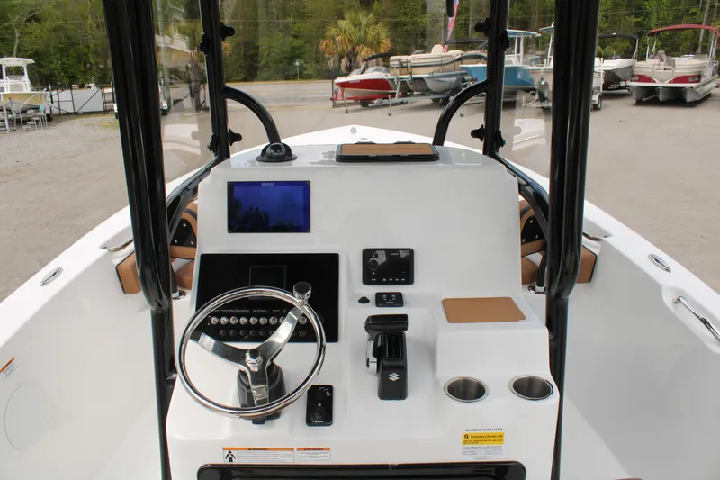 Slide: The Image of 2024 Sea Pro 222 boat dashboard with steering wheel, controls, and navigation screen. - 26