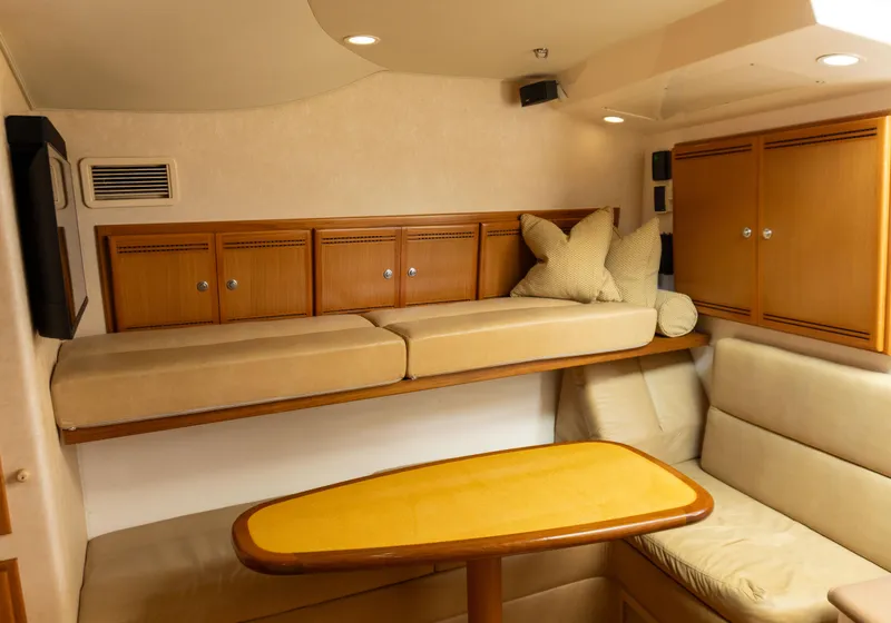 Slide: The Image of Interior of 2008 Cabo 38 Express with cozy seating and wooden cabinetry. - 17