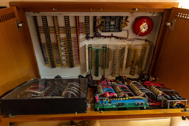 Slide: The Image of Electrical panel of a 2008 Cabo 38 Express boat with wiring and circuit boards. - 20
