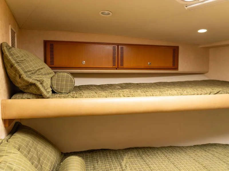 Slide: The Image of Interior cabin of 2008 Cabo 38 Express with bunk beds and storage cabinets. - 22