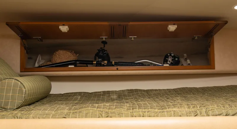 Slide: The Image of Storage compartment in 2008 Cabo 38 Express boat with fishing gear. - 23