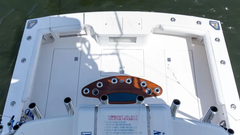 Slide: The Image of 2008 Cabo 38 Express boat deck with fishing rod holders and storage compartments. - 26