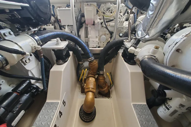 Slide: The Image of Engine room of a 2008 Cabo 38 Express boat with visible hoses and machinery. - 32