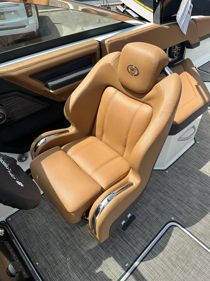Slide: The Image of 2024 Cobalt R4 boat with luxurious tan leather captain's chair. - 12