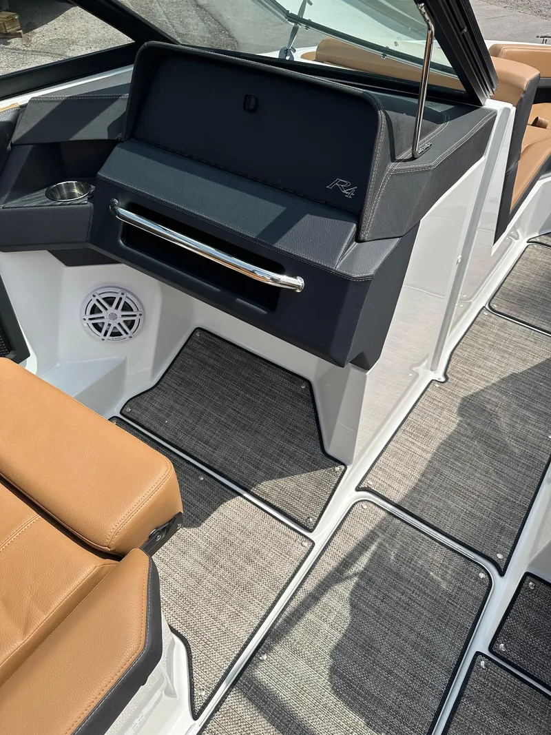 Slide: The Image of 2024 Cobalt R4 boat interior with tan seats and modern dashboard. - 8