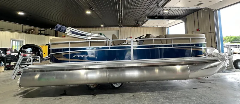 The Image of 2024 Starcraft LX22RDH pontoon boat in a showroom. - 0