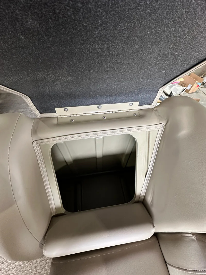 Slide: The Image of 2024 Starcraft LX22RDH boat storage compartment with open lid. - 13