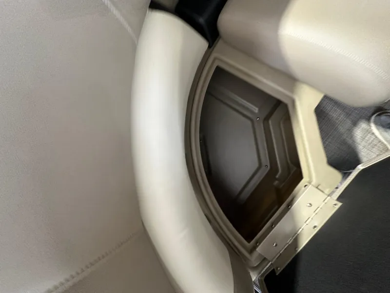 Slide: The Image of 2024 Starcraft LX22RDH boat interior storage compartment with cushioned seating. - 14