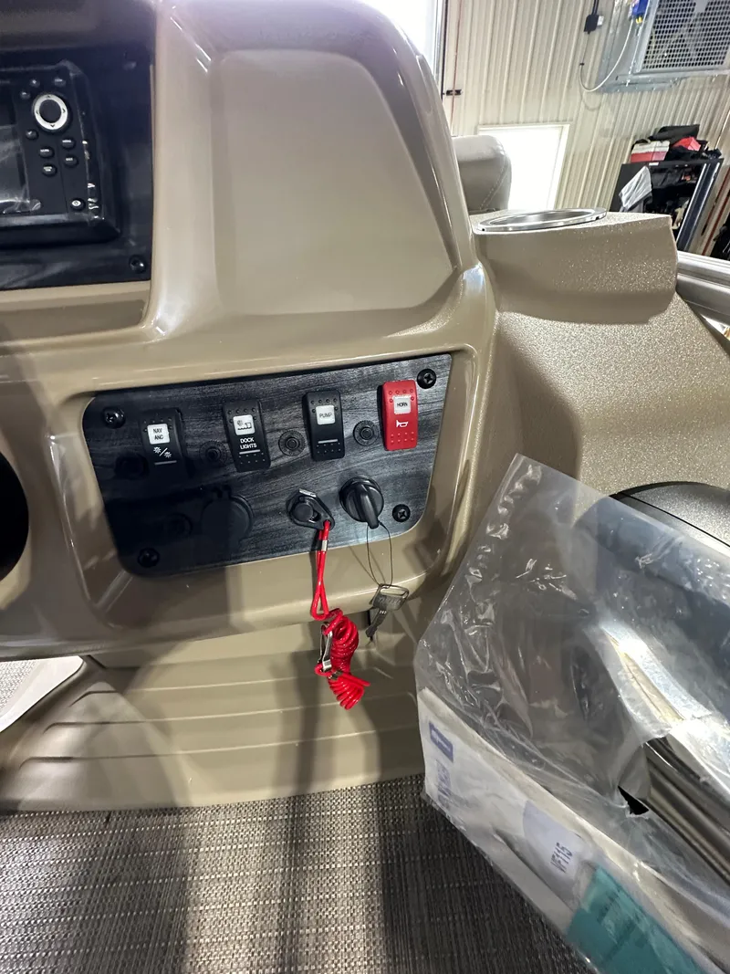 Slide: The Image of Control panel of a 2024 Starcraft LX22RDH boat with switches and safety lanyard. - 17