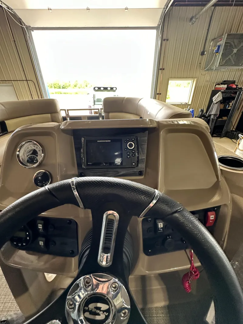 Slide: The Image of 2024 Starcraft LX22RDH boat dashboard with steering wheel and control panel. - 18