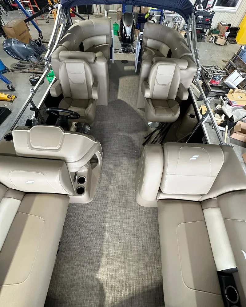 Slide: The Image of 2024 Starcraft LX22RDH pontoon boat interior with beige seating and spacious layout. - 4