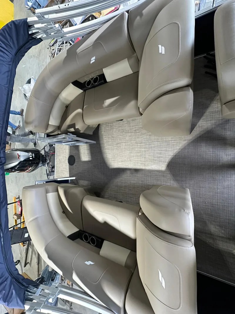 Slide: The Image of 2024 Starcraft LX22RDH pontoon boat interior with beige seating and cup holders. - 5