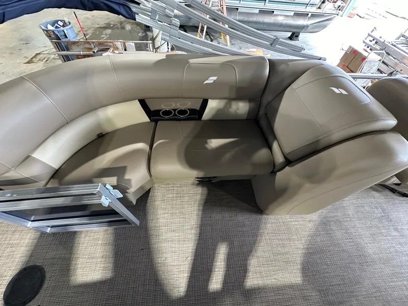 Slide: The Image of 2024 Starcraft LX22RDH boat interior with tan leather seating and cup holders. - 7