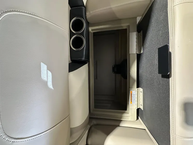 Slide: The Image of 2024 Starcraft LX22RDH boat interior storage compartment with cup holders. - 9
