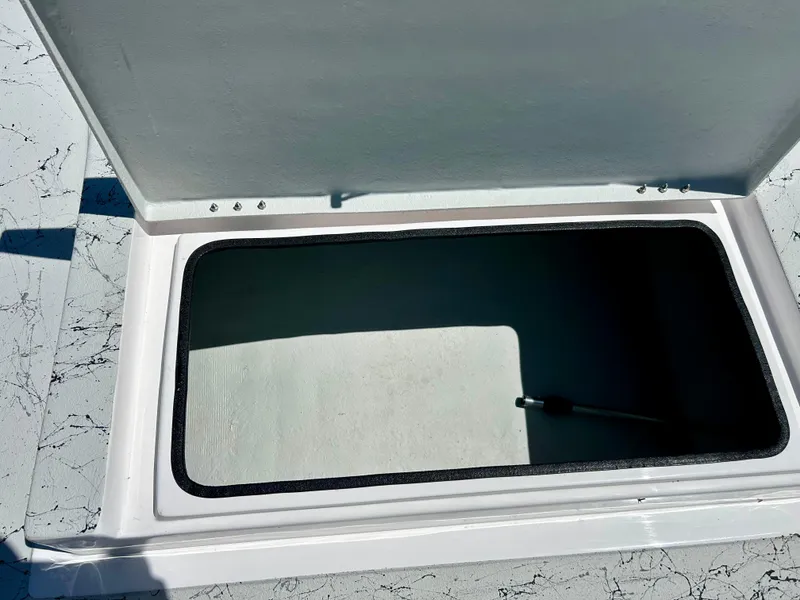 Slide: The Image of Open storage compartment on a 2024 Shallow Stalker 17 LTS boat. - 12