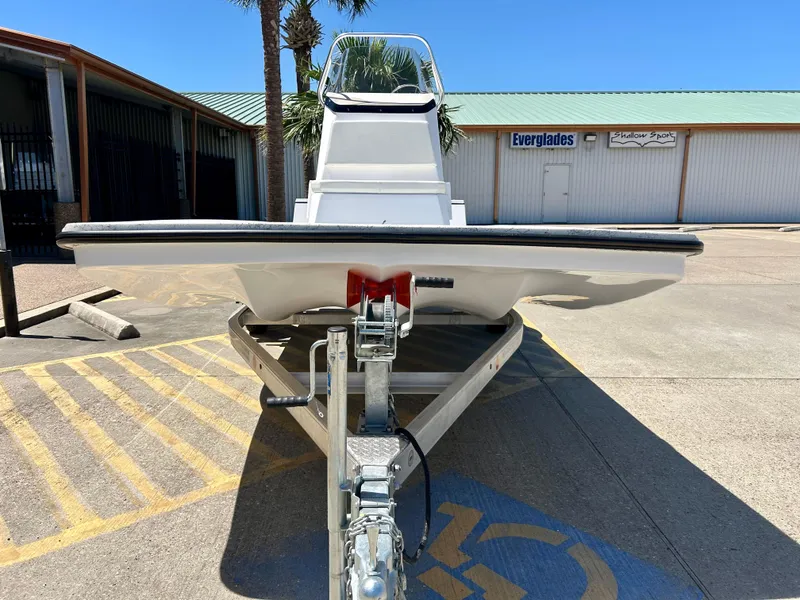 Slide: The Image of 2024 Shallow Stalker 17 LTS boat on a trailer in a parking lot. - 2