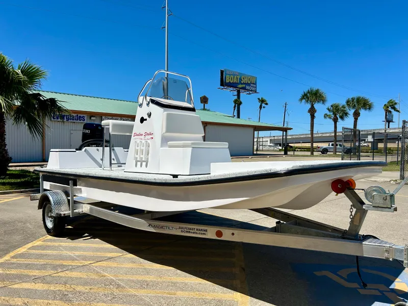 Slide: The Image of 2024 Shallow Stalker 17 LTS boat on a trailer in a sunny outdoor setting. - 3