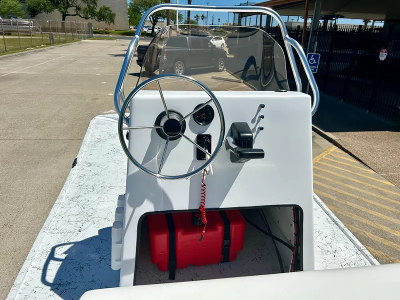 Slide: The Image of 2024 Shallow Stalker 17 LTS boat console with steering wheel and controls. - 8