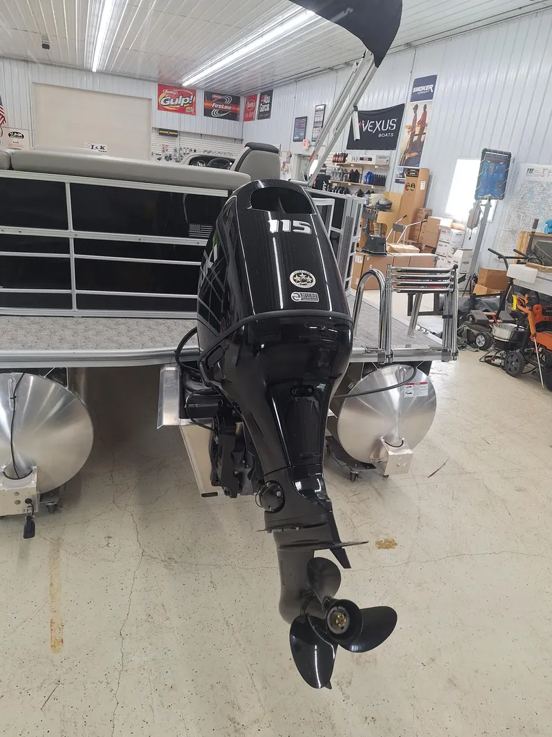 Slide: The Image of 2024 South Bay 222CRLE pontoon boat with outboard motor in showroom. - 11