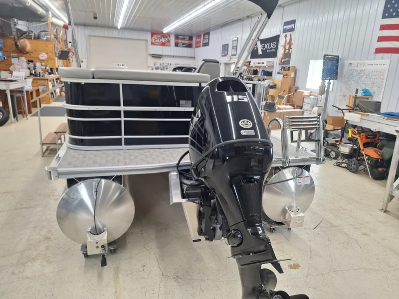 Slide: The Image of 2024 South Bay 222CRLE pontoon boat with 115 horsepower engine in a showroom. - 12