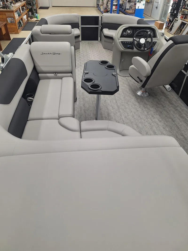 Slide: The Image of 2024 South Bay 222CRLE pontoon boat interior with plush seating and modern helm. - 6
