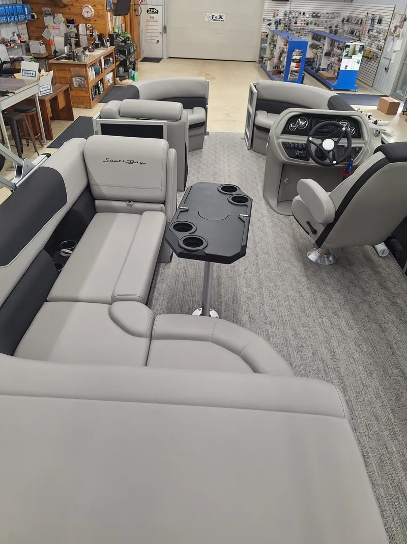 Slide: The Image of 2024 South Bay 222CRLE pontoon boat interior with plush seating and modern helm. - 7