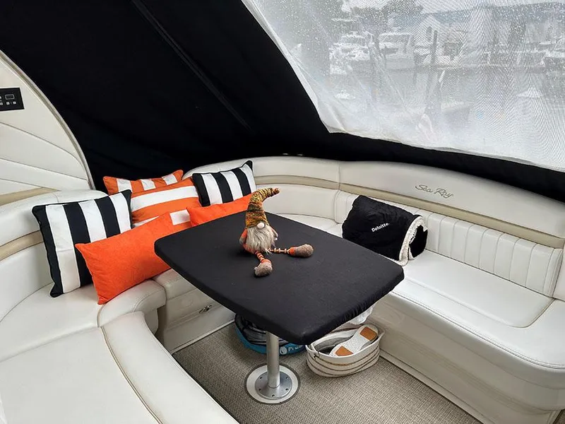 Slide: The Image of Interior seating area of 2009 Sea Ray 40 Sundancer with cushions and table. - 11
