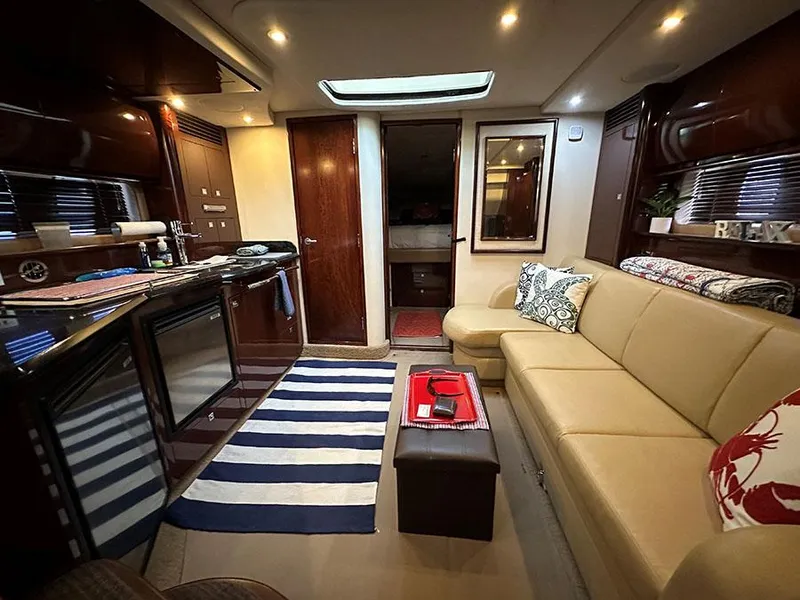 Slide: The Image of Interior of 2009 Sea Ray 40 Sundancer yacht with modern kitchen and cozy seating area. - 14