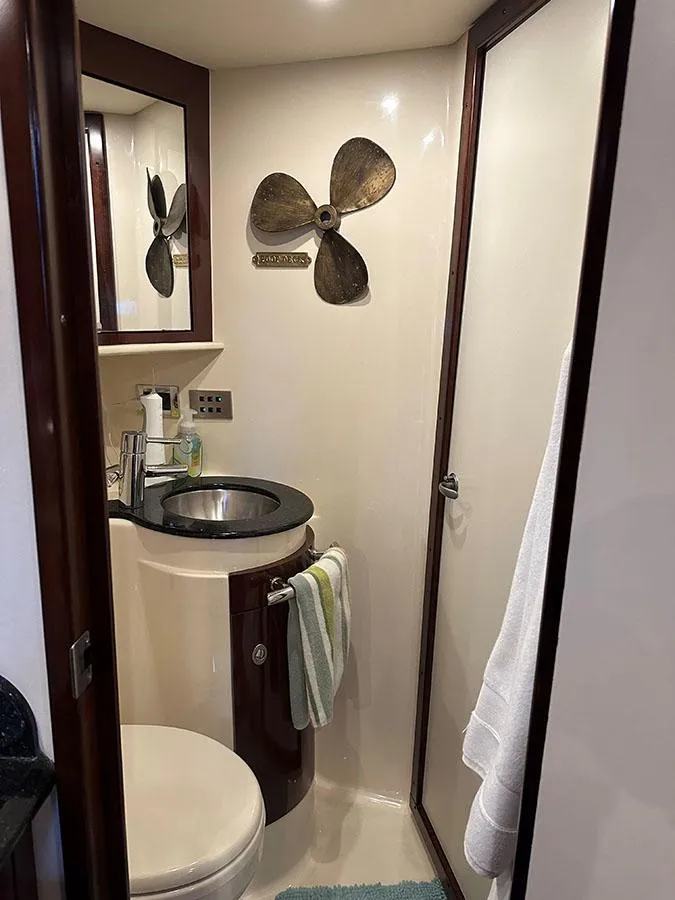 Slide: The Image of 2009 Sea Ray 40 Sundancer bathroom with sink, toilet, and nautical decor. - 15