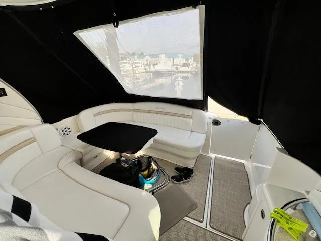 Slide: The Image of Interior of 2009 Sea Ray 40 Sundancer with white seating and black table. - 17
