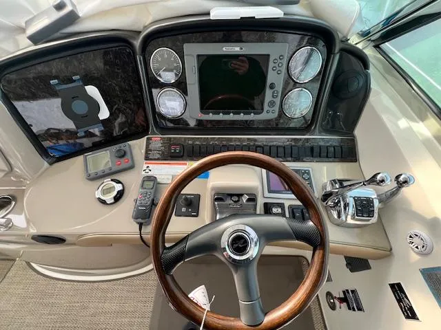 Slide: The Image of Control panel of a 2009 Sea Ray 40 Sundancer yacht with steering wheel and navigation instruments. - 18