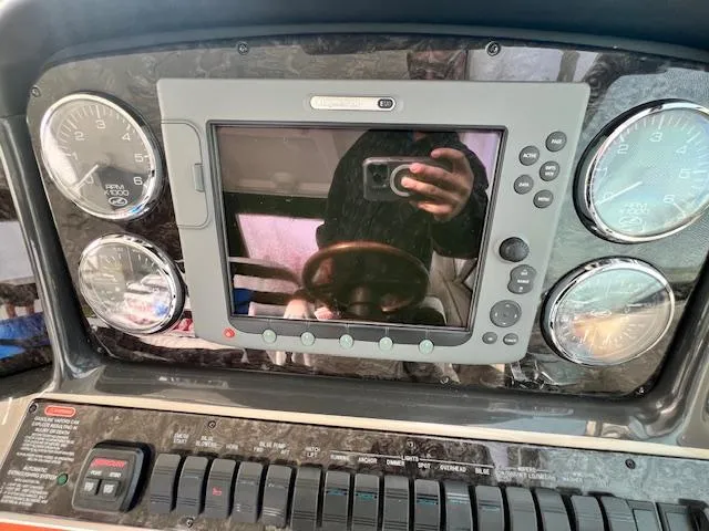 Slide: The Image of Dashboard of a 2009 Sea Ray 40 Sundancer boat with gauges and a central display. - 20