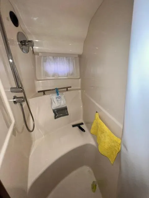 Slide: The Image of 2009 Sea Ray 40 Sundancer bathroom with shower and yellow towel. - 24