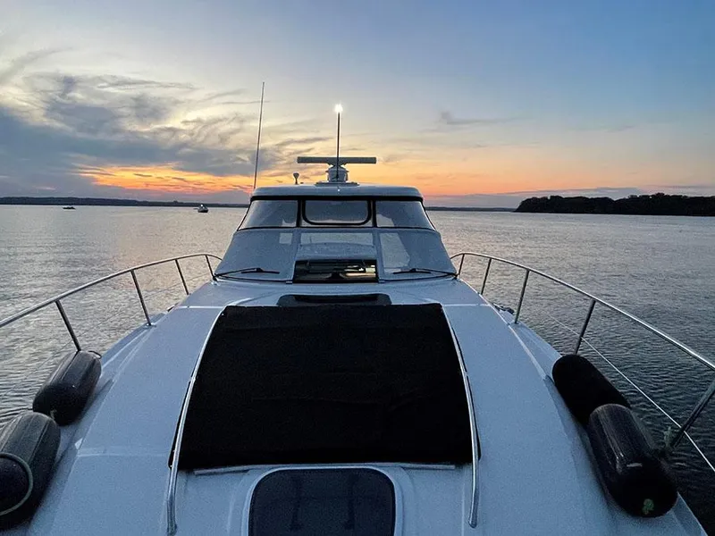 Slide: The Image of 2009 Sea Ray 40 Sundancer yacht at sunset on calm waters. - 5