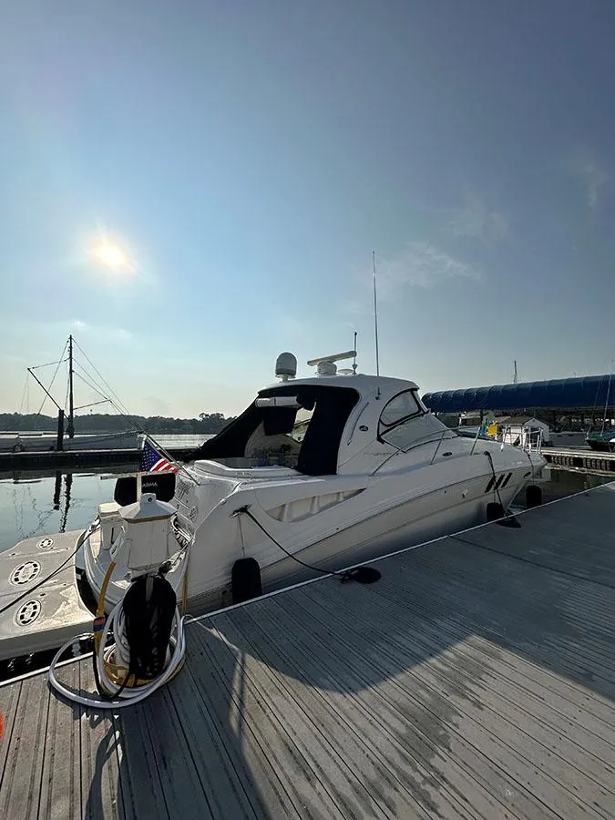 Slide: The Image of 2009 Sea Ray 40 Sundancer docked at marina under clear sky. - 7