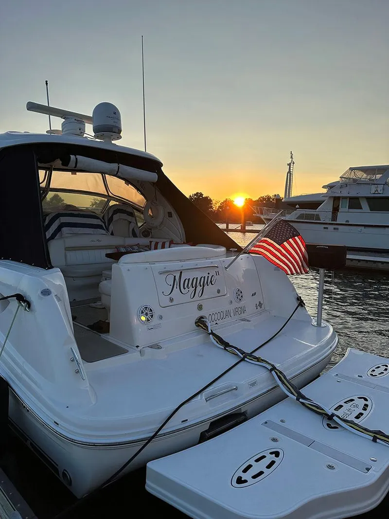 Slide: The Image of 2009 Sea Ray 40 Sundancer yacht Maggie docked at sunset with American flag. - 8