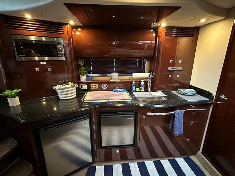 Slide: The Image of Luxurious kitchen area in a 2009 Sea Ray 40 Sundancer yacht with modern appliances. - 9