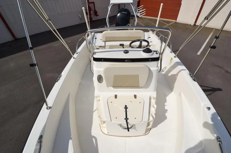 Slide: The Image of 2019 Boston Whaler 180 Dauntless boat interior with steering console and seating. - 11