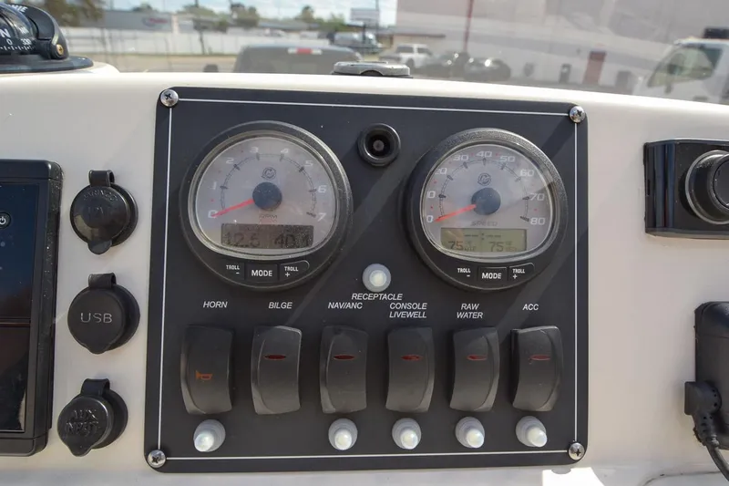 Slide: The Image of 2019 Boston Whaler 180 Dauntless dashboard with gauges and switches. - 13
