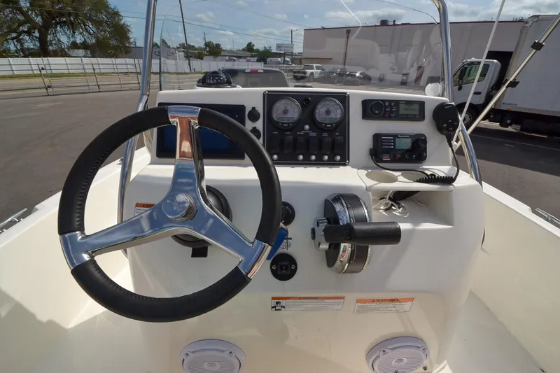 Slide: The Image of 2019 Boston Whaler 180 Dauntless boat console with steering wheel and control panel. - 14