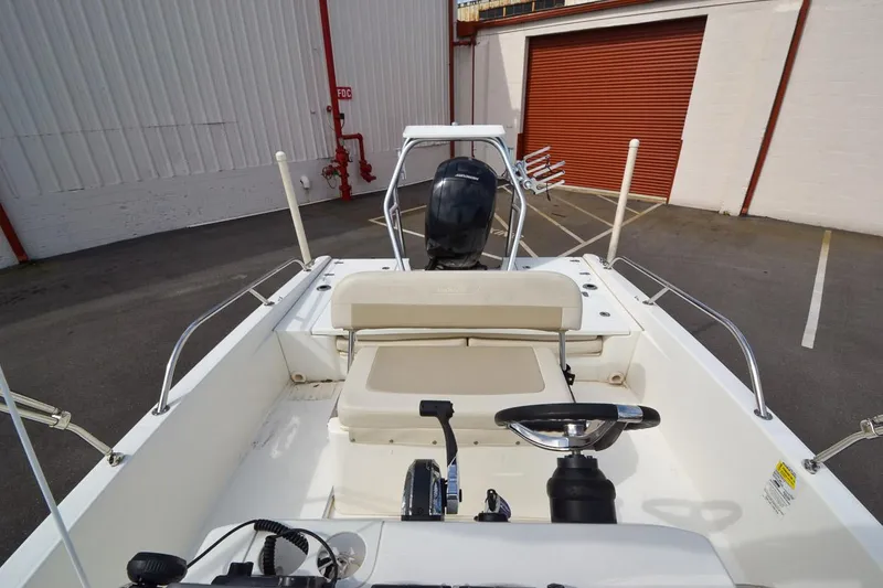 Slide: The Image of 2019 Boston Whaler 180 Dauntless boat interior with steering wheel and seating. - 16
