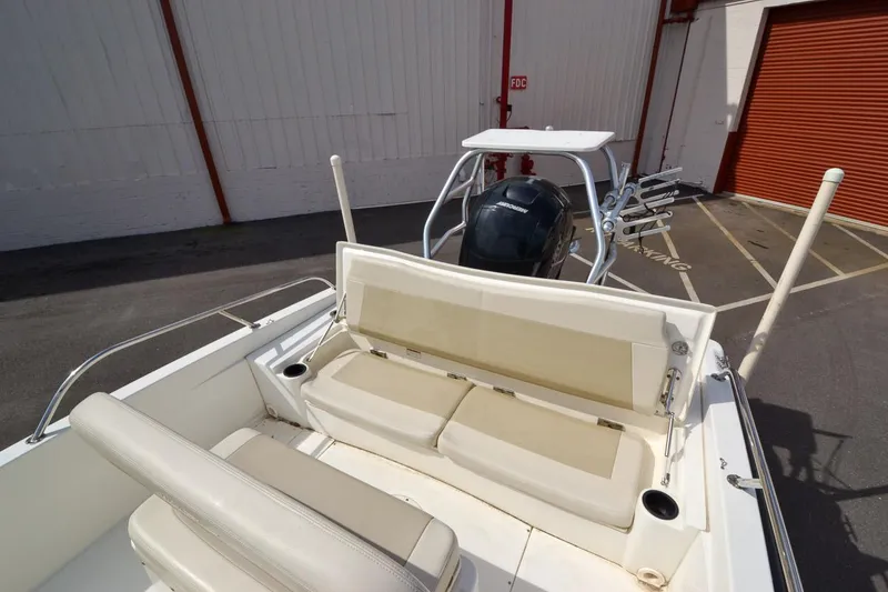 Slide: The Image of 2019 Boston Whaler 180 Dauntless boat interior with seating and motor. - 18