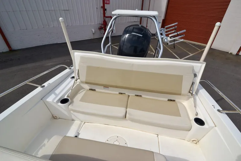 Slide: The Image of 2019 Boston Whaler 180 Dauntless boat with beige seating and outboard motor. - 19