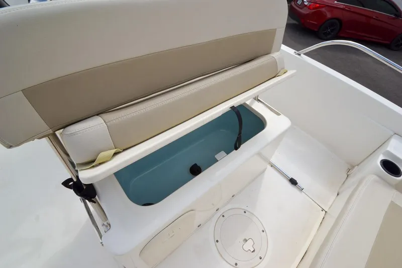 Slide: The Image of 2019 Boston Whaler 180 Dauntless boat seat with storage compartment open. - 20